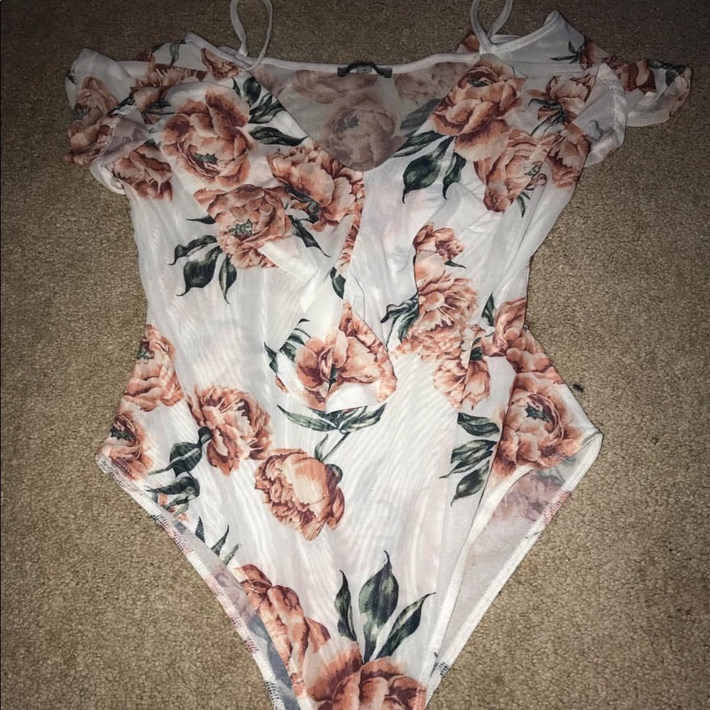 An off the shoulder body suit